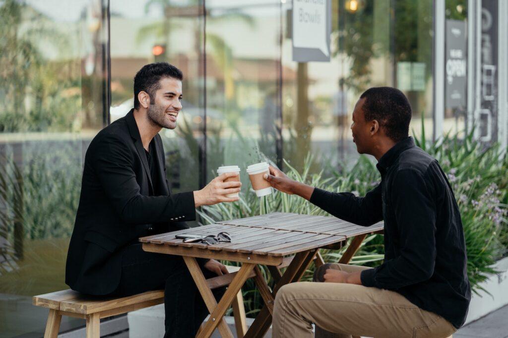 Image of two men talking over a coffee. Talking can help with seasonal affective disorder SAD