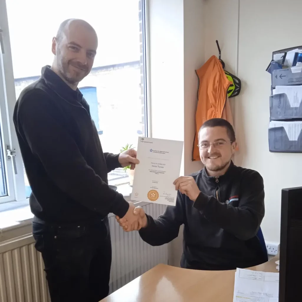 Photo of Dan, who has completed his team leader apprenticeship, being presented his certificate by Sales and Marketing Manager, Brad Robinson