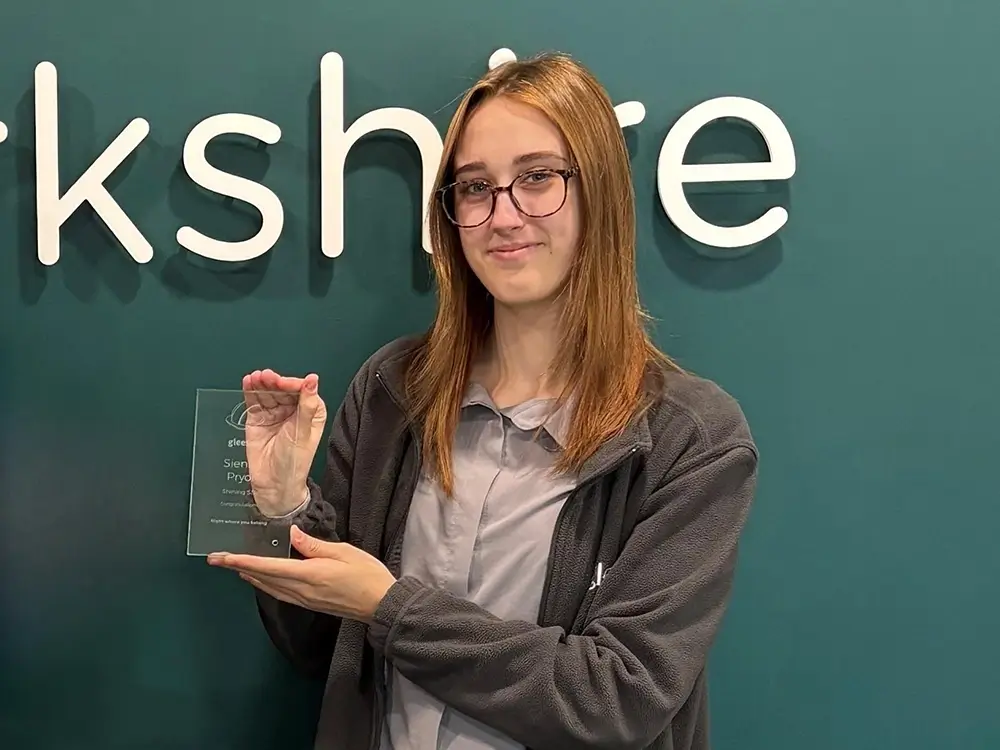 Photo of Award-Winning Administrator Apprentice, Sienna, holding her award