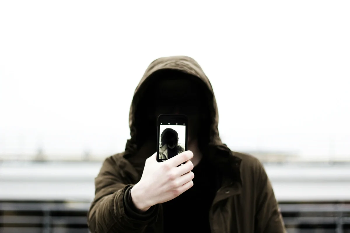 Photo of someone hidden on the phone, to show incels can be anyone you know. 